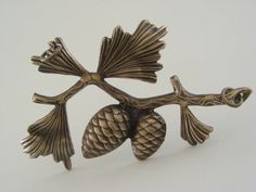 an image of a brooch with two acorns on it