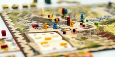 a close up of a board game with people on it