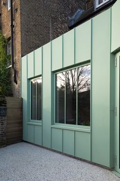 an empty building with green walls and windows