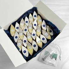 a box filled with lots of white and blue decorated ceramic items on top of a table