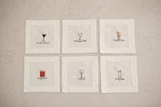 four embroidered napkins with different types of drinks on them, arranged in the shape of squares