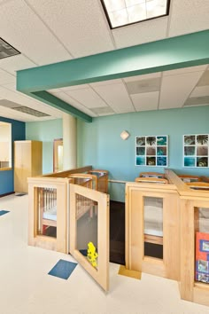 a child's playroom with blue walls and white carpeted flooring is shown