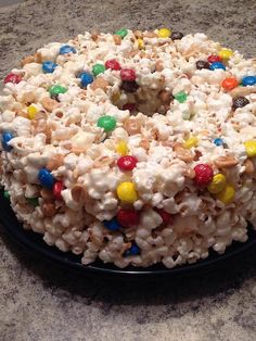 a cake covered in candy and cereal on top of a table