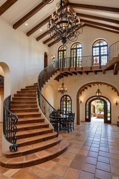 a large foyer with stairs and chandelier