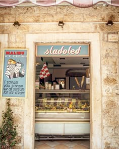 a store front with an open window and signs on the wall above it that read, saubled