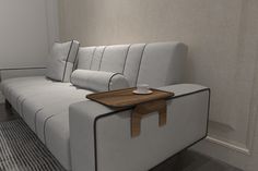 a white couch with a wooden tray on it