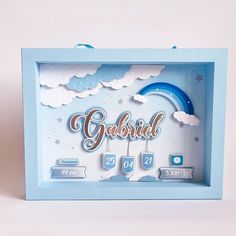 a blue frame with the word gabbie on it and clouds in the background