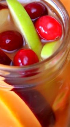 a glass jar filled with liquid and fruit