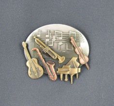 "Five beautifully detailed Instruments in brass and copper are soldered to a sterling silver plated sheet music stamping, which shows off each and every instrument. It is oxidized to bring out the detail, hand satined and lacquered to insure it will never tarnish. No special catre is required. Amazingly light weight. A perfect gift for the music teacher, music lover or music enthusiast. Gift Boxed Measures 1 7/8\" x 1 5/8\" Thank you for visiting my shop and please come again. Many more Brooches Music Teacher Gift, Brass Instrument, Copper Gifts, Music Teacher Gifts, Brass And Copper, Musician Gifts, Jazz Club, Gift For Music Lover, Music Teacher