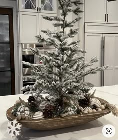 a white christmas tree sitting on top of a wooden tray