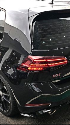 the back end of a black car with its trunk open