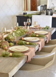 a dining room table set with place settings