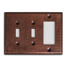 an old fashioned copper metal switch plate with two white plates on the front and one light switch