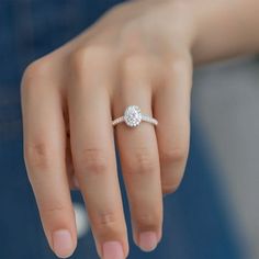 a woman's hand with a diamond ring on it