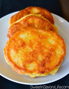 three pancakes sitting on top of a white plate