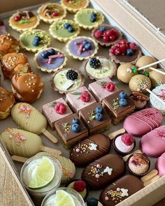 a box filled with lots of different types of cakes and desserts on top of each other