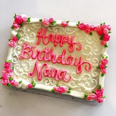 a birthday cake with the words happy birthday nanna written on it and pink flowers