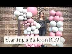 a woman standing in front of a balloon letter that says, starting a balloon biz?