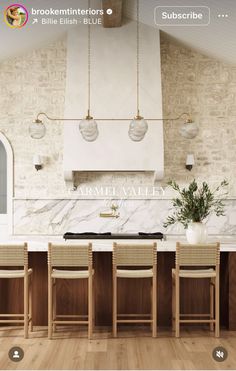 an image of a kitchen with marble counter tops and wooden chairs in front of the stove