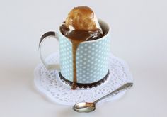 a cup filled with ice cream sitting on top of a white doily