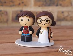 a wedding cake topper with a bride and groom figurine next to each other