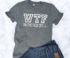 a t - shirt that says witf with the face off in white on it