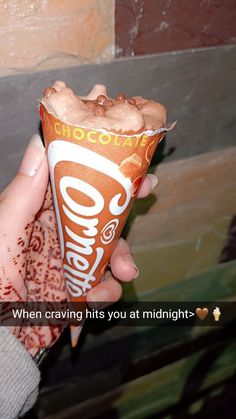 someone holding up a chocolate ice cream cone with the words, when crave hits you at midnight