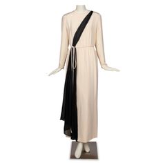 Step Out In Timeless Elegance With This Exquisite 1986 Bill Blass Gown In Striking Black And Ivory. The Long Sleeve Gown Features Luxurious Ivory Crepe De Chine Fabric With Striking Black Diagonal Chiffon Trim Extending From The Left Shoulder Down To The Right Hip, Creating A Visually Stunning And Flattering Silhouette. Fully-Lined With A Center Back Zipper Closure, Functional Buttons At The Cuffs, And A Built-In Cord Tie At The Waist, This Gown Is Effortless Style. Crafted In The Usa, This Vint Sleeve Gown, Long Sleeve Gown, Iconic Fashion, Bill Blass, Vintage Fall, Runway Show, Fashion Designer, Effortless Style, Fashion Statement