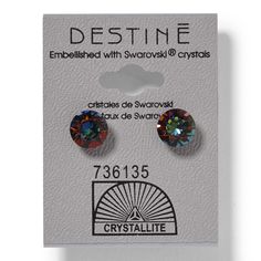 the crystal stone earrings are on display in front of a white card that says destine