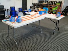 a white table with blue and orange bags on it