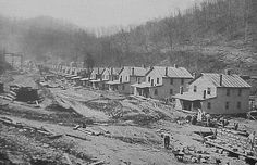 an old black and white photo of houses under construction