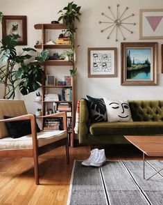 a living room filled with furniture and pictures on the wall