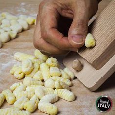 a person is cutting up some food on a table