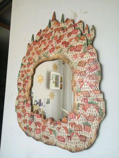 a decorative mirror hanging on the wall above a sink in a room with white walls