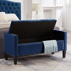 a bed with a blue velvet upholstered frame