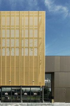 the building has many windows on it and is made out of gold foiling material