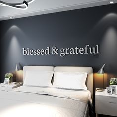 there is a bed with white sheets and pillows in the room that says, blessing & grateful