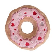 a donut with pink frosting and hearts on it