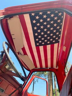 an american flag painted on the side of a red truck's cab door window