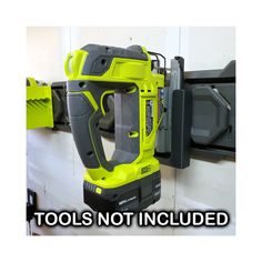 a cordless driller is mounted on the wall next to a tool holder that says tools not included