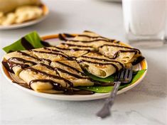 a plate topped with banana slices covered in chocolate sauce and drizzled on top