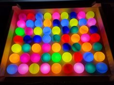 a box filled with lots of different colored balls