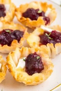 mini pies filled with cranberry sauce on a plate