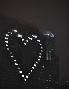 a large heart shaped building lit up at night