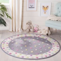 a child's room with a chair, rug and pictures on the wall