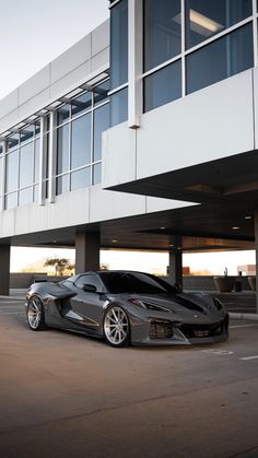 a black sports car parked in front of a building