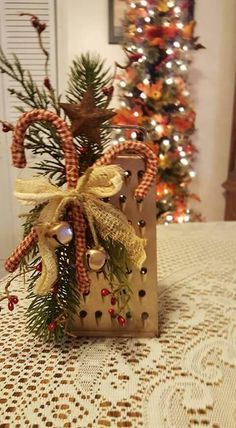 a christmas decoration on a table next to a tree