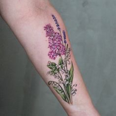 a woman's arm with flowers and leaves on the left side of her body