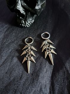 Spikes & rings galore perfectly layered on antique silver coloured earring hoops. ✦ 2.5" full drop. ✦ 0.5" hoop. ✦ Gauge stretcher tunnel friendly. ✦ Lead & nickel free ✦ Alloy metal. ✦ Comes gift wrapped with a little something extra! ~ BE ✦ 𝖄𝕺𝖀 ✦ NIQUE ✦ * Orders posted out daily worldwide. * Fashion/costume jewellery for those who dare to be different. * Follow me on Instagram, Twitter & Facebook for everything * heavymetal * goth * grunge * alternative * pagan * streetwear * metalhead * v Punk Metal Jewelry For Concerts, Punk Style Metal Jewelry For Concerts, Emo Style Pierced Metal Earrings, Nickel Free Silver Emo Earrings, Silver Emo Earrings For Parties, Nickel-free Silver Emo Earrings, Silver Nickel-free Emo Earrings, Punk Style Nickel-free Jewelry, Punk Style Nickel-free Jewelry For Concerts