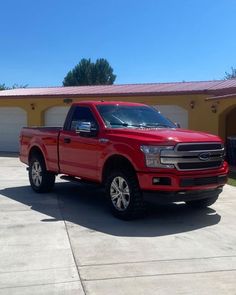 a red truck parked in front of a house